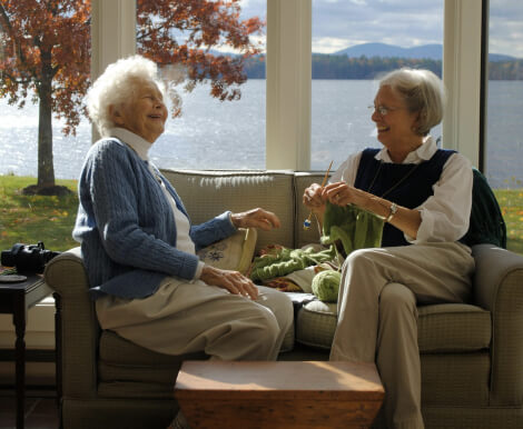 Two Elderly Woman Talking and Enjoying the Lake View in Wichita Falls Assisted Living Facility Two Elderly Woman Talking and Enjoying the Lake View in Wichita Falls Assisted Living Facility